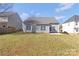 Fenced backyard showing the home's back windows, door, and grassy lawn at 1911 Kingstree Dr, Monroe, NC 28112