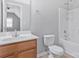 Bright bathroom with tub shower, light wood vanity, and ceramic tile flooring at 1911 Kingstree Dr, Monroe, NC 28112