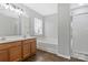 Well-lit bathroom features a double vanity, soaking tub, and glass-enclosed shower at 1911 Kingstree Dr, Monroe, NC 28112