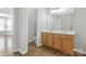 Bathroom with double sink vanity featuring wood cabinets and modern fixtures at 1911 Kingstree Dr, Monroe, NC 28112