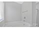 Bathroom features a soaking tub with chrome fixtures and tiled surround at 1911 Kingstree Dr, Monroe, NC 28112