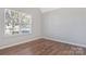 Neutral bedroom design showcases vinyl floors and a large window at 1911 Kingstree Dr, Monroe, NC 28112