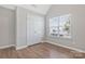 This bedroom features wood-look floors, closet, and natural light at 1911 Kingstree Dr, Monroe, NC 28112