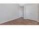 Bedroom featuring wood-look vinyl floors and a double-door closet at 1911 Kingstree Dr, Monroe, NC 28112