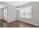 Cozy dining area featuring hardwood floors, natural light, and classic chandelier at 1911 Kingstree Dr, Monroe, NC 28112