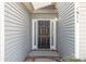 A welcoming front door is framed by sidelights and siding, creating an inviting entrance to this home at 1911 Kingstree Dr, Monroe, NC 28112