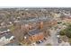 Aerial view of brick building featuring large windows and parking, surrounded by mature trees at 201 Hoskins S Rd # 124, Charlotte, NC 28208