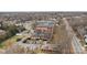 Wide aerial shot of a brick building with parking and verdant surroundings at 201 Hoskins S Rd # 124, Charlotte, NC 28208