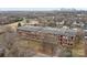 Brick building featuring large windows with skyline in background and mature trees at 201 Hoskins S Rd # 124, Charlotte, NC 28208