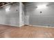 Spacious empty room with hardwood floors, neutral walls, and a door at 201 Hoskins S Rd # 124, Charlotte, NC 28208