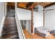 Cozy living room with hardwood floors, exposed beams, and a staircase at 201 Hoskins S Rd # 124, Charlotte, NC 28208