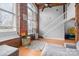 Bright living room featuring exposed brick walls, large windows, and a modern staircase at 201 Hoskins S Rd # 124, Charlotte, NC 28208