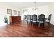 Dining room with wood floors, a large table with seating for eight, and an elegant light fixture at 269 Loch Stone St, Fort Mill, SC 29715