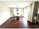 Cozy dining area with wood floors, a chandelier, curtains, and a sliding glass door at 269 Loch Stone St, Fort Mill, SC 29715