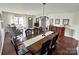 Inviting dining room featuring a long wooden table, elegant chandelier, and views to the front of the home at 269 Loch Stone St, Fort Mill, SC 29715