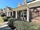 Inviting brick facade with manicured bushes, hanging flower baskets, and a welcoming front porch at 269 Loch Stone St, Fort Mill, SC 29715