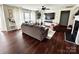 Comfortable living room featuring hardwood floors, a ceiling fan, a fireplace, and ample natural light at 269 Loch Stone St, Fort Mill, SC 29715