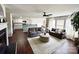 Open living space with hardwood floors, a fireplace, neutral walls and modern ceiling fan leading to the kitchen at 269 Loch Stone St, Fort Mill, SC 29715