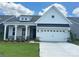 Charming two-story home featuring a modern farmhouse design and well-maintained landscaping at 324 Basil Dr, Indian Trail, NC 28079