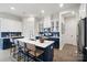 Beautiful kitchen with white cabinets, navy island, stainless appliances, and hardwood floors at 324 Basil Dr, Indian Trail, NC 28079