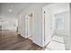 Bright hallway with hardwood floors and white walls and trim leading to multiple rooms at 4011 Vista Pine Dr, Charlotte, NC 28215