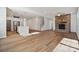 Spacious open concept living and kitchen area with hardwood flooring and stone fireplace at 4011 Vista Pine Dr, Charlotte, NC 28215