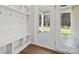 Well-organized mudroom with bench, hooks, and access to the outdoors at 4011 Vista Pine Dr, Charlotte, NC 28215