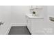 Bright laundry room featuring a white countertop, cabinets, and gray tile flooring at 4069 Rivendell Rd # 5, Denver, NC 28037