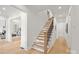 A light wood staircase with black metal railing leads to the upper level of this modern home at 4069 Rivendell Rd # 5, Denver, NC 28037