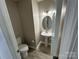 Small bathroom with a pedestal sink and toilet at 4904 Cornelia Dr, Charlotte, NC 28269