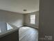 This is a cozy bedroom with modern floors, neutral paint, and natural light at 4904 Cornelia Dr, Charlotte, NC 28269