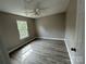 This bedroom is bright, with neutral walls and modern laminate wood-look flooring at 4904 Cornelia Dr, Charlotte, NC 28269