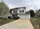 Charming two-story home featuring a large concrete driveway and attached two-car garage at 4904 Cornelia Dr, Charlotte, NC 28269