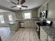 Updated kitchen showcasing granite counters, a ceiling fan, and stainless appliances at 4904 Cornelia Dr, Charlotte, NC 28269