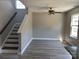 A cozy living room with a staircase and wood-look floors at 4904 Cornelia Dr, Charlotte, NC 28269