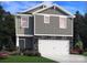 Charming two-story home with a stone-accented facade, attached garage, and professionally landscaped front yard at 5015 Poplin Vly, Cherryville, NC 28021