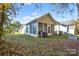 Backyard featuring a sunroom, leafy trees, and green grass at 541 Settlers Grove Ln # 49, Salisbury, NC 28146