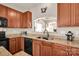 Cozy kitchen featuring granite countertops, wood cabinets, and modern black appliances at 541 Settlers Grove Ln # 49, Salisbury, NC 28146