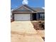 Charming single-story home featuring a stone facade, a two-car garage, and a well-manicured lawn at 5618 Skinny Dr, Charlotte, NC 28215