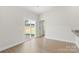 Open living space with sliding glass doors, and a door to a bedroom and modern flooring for easy maintenance at 5618 Skinny Dr, Charlotte, NC 28215