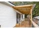 Covered back porch with wooden railing and a view of the backyard at 6106 Ashley Dr, Concord, NC 28025