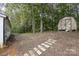 View of the backyard with shed and walkway at 6106 Ashley Dr, Concord, NC 28025