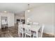 Bright dining area with white table and chairs, offering a view into the living room at 6106 Ashley Dr, Concord, NC 28025