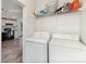 Bright laundry room featuring washer, dryer, and shelf storage at 6106 Ashley Dr, Concord, NC 28025