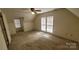 Bedroom featuring a ceiling fan, neutral walls, carpet flooring, and natural light through windows at 618 Camp Rotary Rd, Gastonia, NC 28052