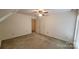 Spacious bedroom with carpet, fan, and doorways at 618 Camp Rotary Rd, Gastonia, NC 28052