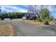 Long driveway leading to a home with a stone facade and metal roof at 618 Camp Rotary Rd, Gastonia, NC 28052