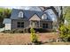 Charming home featuring a stone facade, black shutters, and a metal roof at 618 Camp Rotary Rd, Gastonia, NC 28052