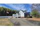 View of the home's side and backyard, featuring a metal roof and white siding at 618 Camp Rotary Rd, Gastonia, NC 28052