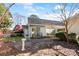 Landscaped backyard with mature trees, a concrete patio, and a quaint white picket fence at 657 Heathridge Rd, Rock Hill, SC 29732